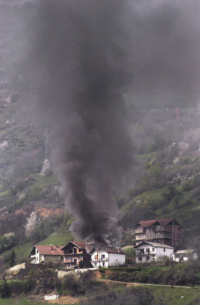 A house caught fire after heavy artillery shelling in support of advancing Macedonian troops.