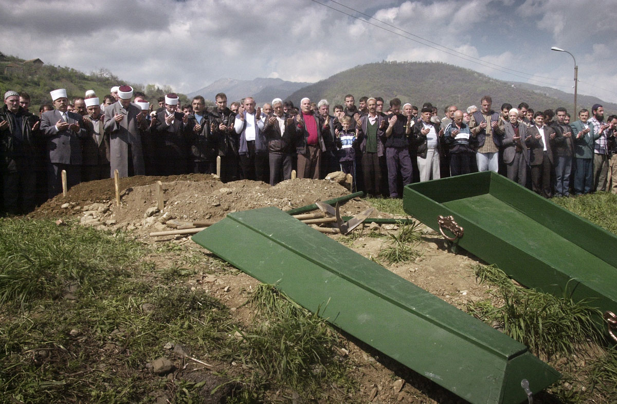 Ethnic Albanians pray during the burial ceremony of a fallen KLA rebel at the Muslim cemetery in Tetovo.