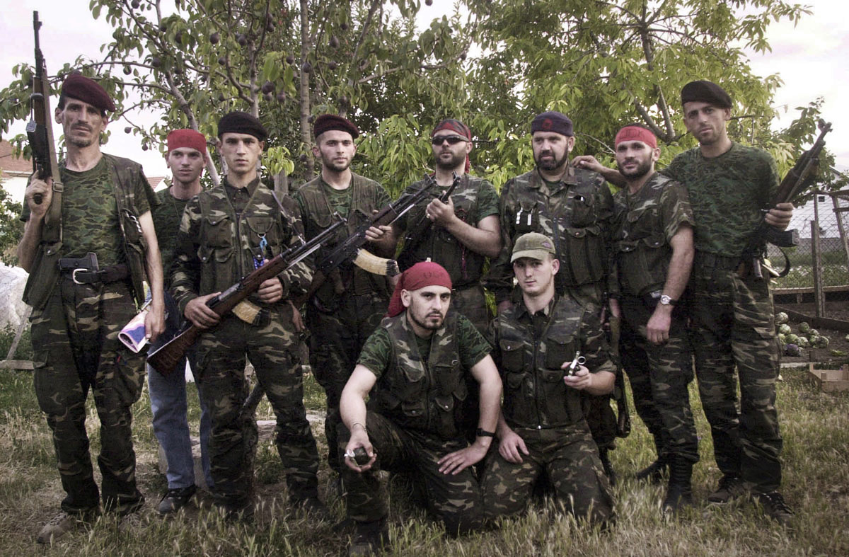 KLA rebels pose in the village of Arachinovo before going out on a night patrol